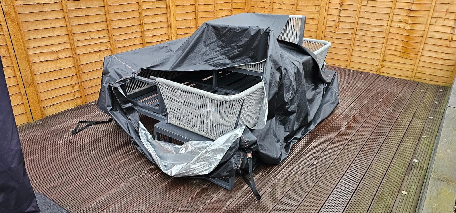 A cheap cover collapsed over garden furniture